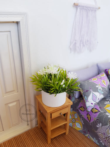 Faux White Flowers in White Plastic Pot